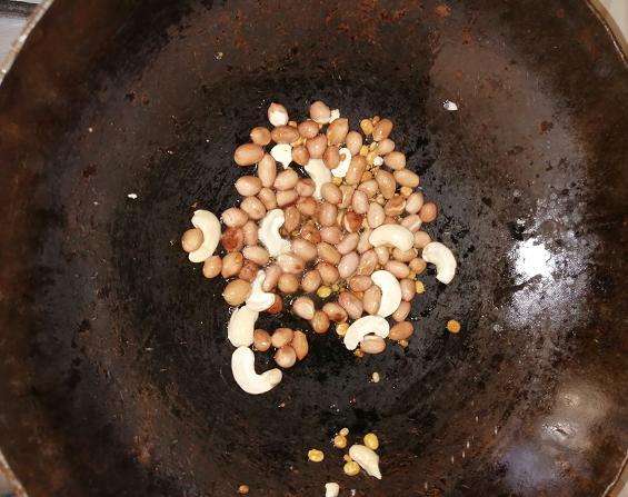 Take a pan add in oil, channa and urad dal, peanuts and cashew nuts.