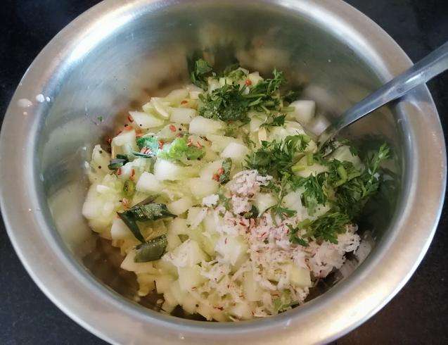 Add in tadka, grated coconut, chopped coriander leaves.