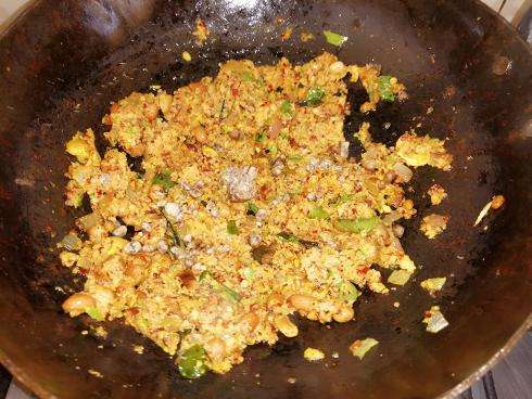 Add in the paste, hing and salt to the seasoning and fry for 2 minutes in low flame.