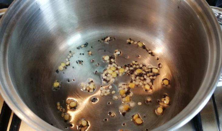 Take a pan and add in oil, mustard seeds, channa and urad dal.