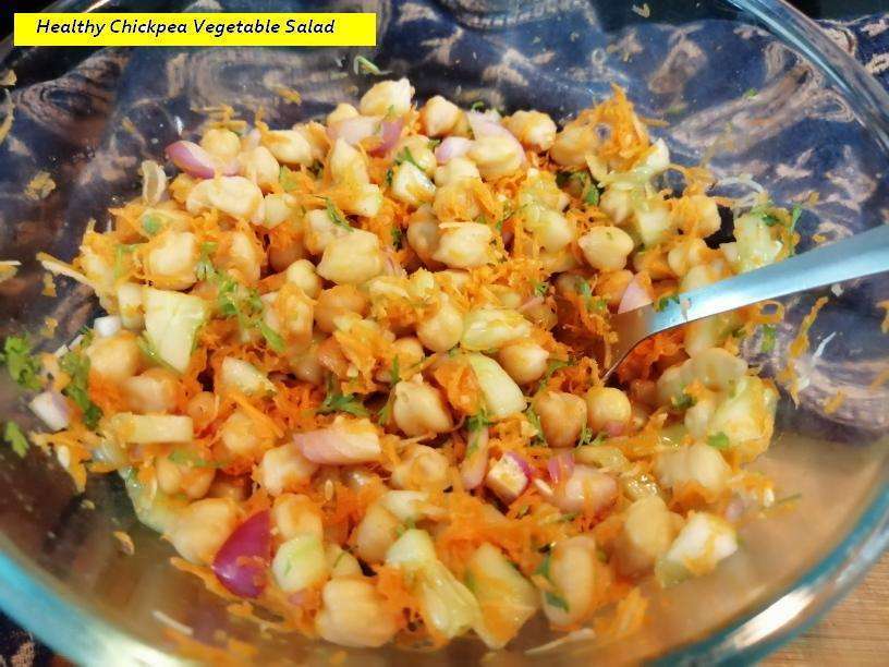 Give a quick mix and serve the healthy chickpea vegetable salad.