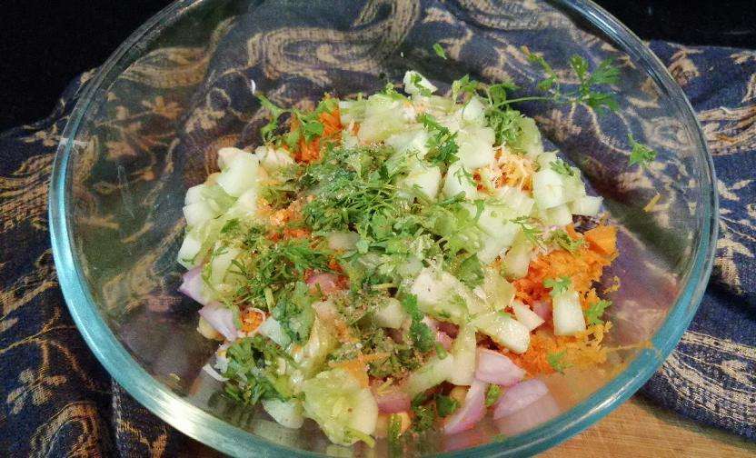 Add in chopped cucumber and coriander leaves, salt and chili powder.