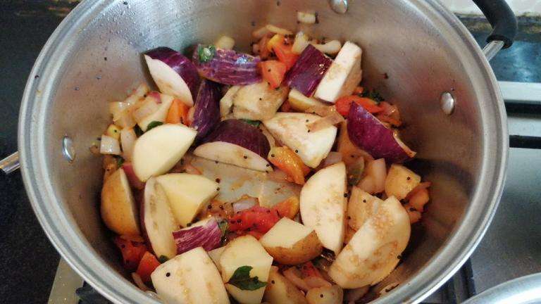 Add in cut brinjal and potatoes.