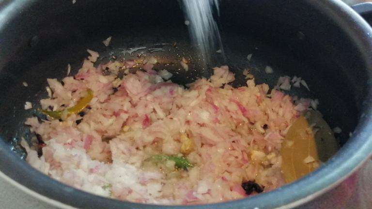 Add in chopped onion and salt. Fry onion till golden brown.