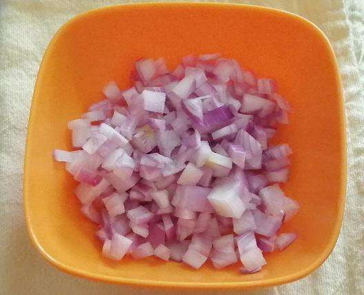 Take a bowl and add in chopped onions.