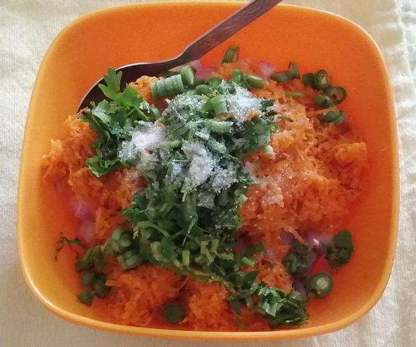 Add in chopped beans. grated carrots, chopped coriander and curry leaves, salt as per taste.