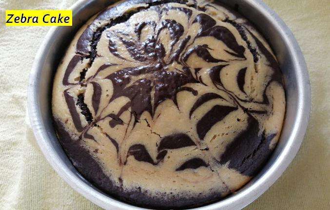 After making the batters, take a cake pan and add one scoop of vanilla batter and again add chocolate cake batter. Likewise add both the batters alternatively. And with the help of spoon or knife make a lines of your choice.