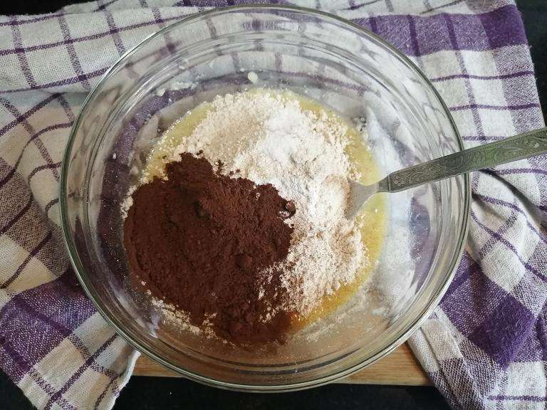 Add in wheat flour, cocoa powder, baking soda, baking powder, sugar and a pinch of salt. Give a gentle mix.