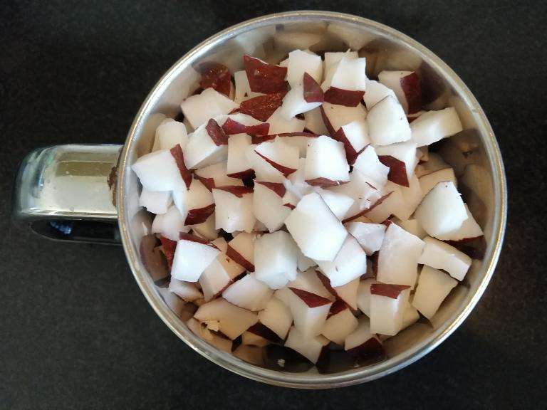 Take a mixer jar and add in chopped coconuts and give a pulse them for few seconds (grated consistency)