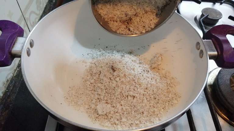 Heat the pan and add in grated coconuts.