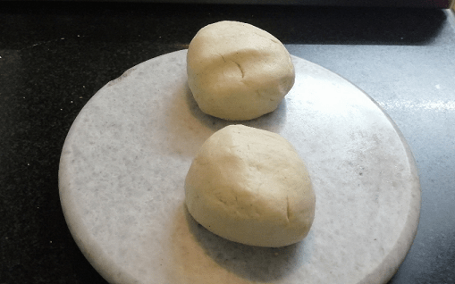 Now divide the dough into two equal balls and keep it aside.