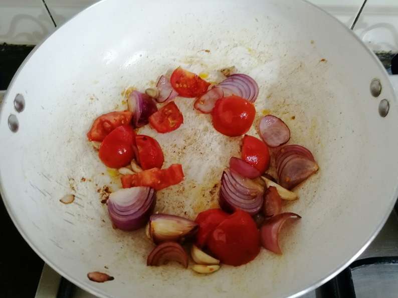 Heat a pan and add in oil, onion, tomato, ginger and garlic.