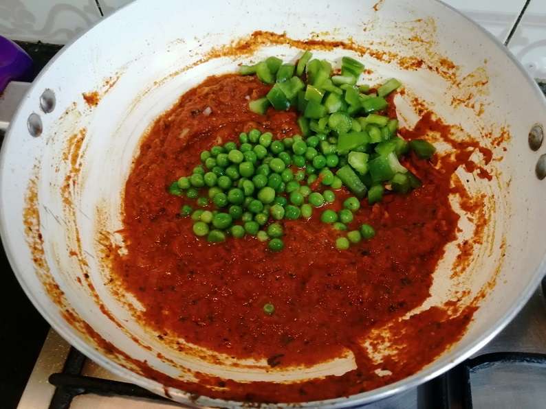 Add in frozen peas and chopped capsicum. Give a mix and cook for another 2 minutes in low flame.