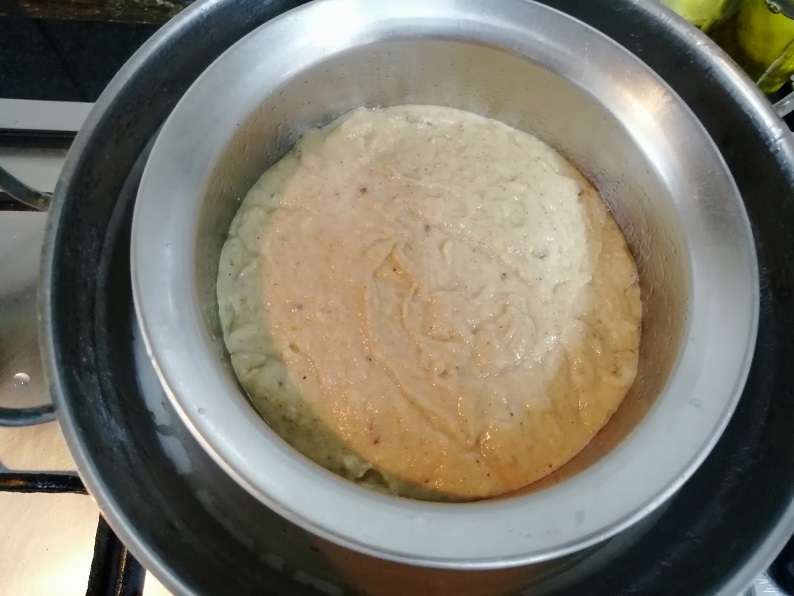 Place a cake pan on the stand. Then close the lid and stem cook them for 25 minutes in low flame.