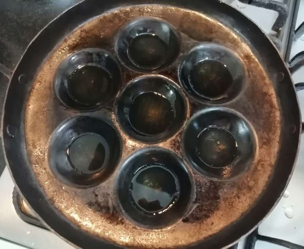 Heat a appam pan and add in required amount of oil.