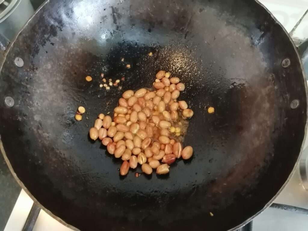 Heat a pan and add in oil, mustard seeds, channa dal, urad dal, peanuts and fry till it slightly changes its color.