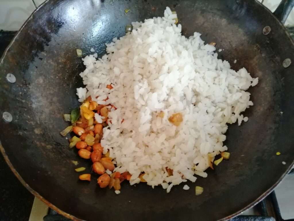 Now add in washed, soaked and drained flatten rice or poha and give a mix.