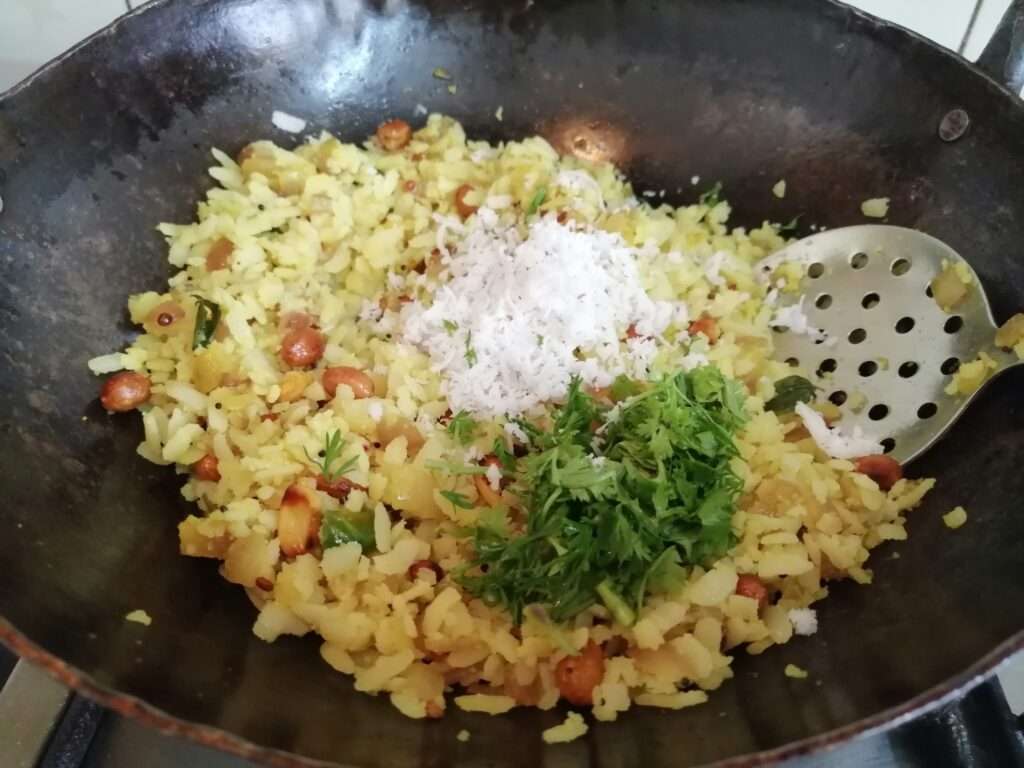 Now add in grated coconut and coriander leaves, then give a mix.