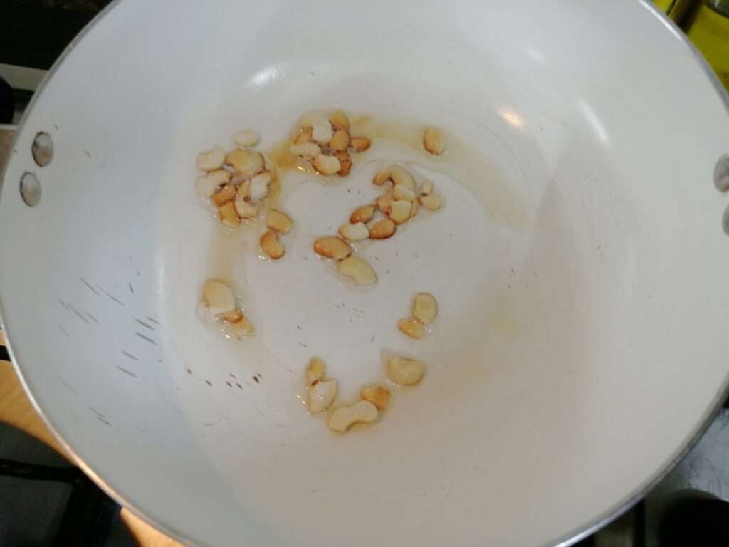 Heat a pan and add in oil and cashew nuts, fry till it slightly changes its color. And keep it aside.